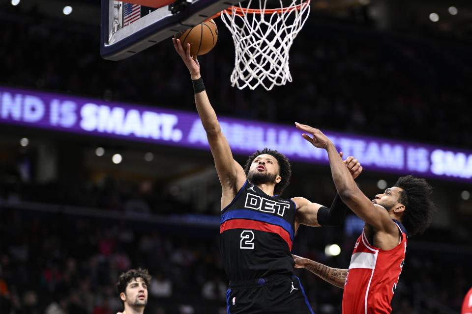 Detroit Pistons guard Cade Cunningham (2) goes to the basket past Washington Wizards forward Marvin Bagley III, right, during the first half of an NBA basketball game Friday, March 29, 2024, in Washington. (AP Photo/Nick Wass)