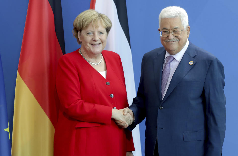 German Chancellor Angela Merkel, left, and Palestinian President Mahmoud Abbas, right, shake hands after a joint statement prior to a meeting at the Chancellery in Berlin, Germany, Thursday, Aug. 29, 2019. (AP Photo/Michael Sohn)