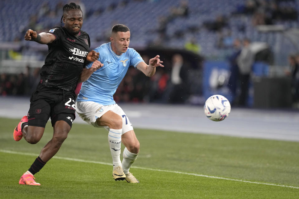 Salernitana's Chukwubuikem Ikwuemesi, left, challenges for the ball with Lazio's Adam Marusic during the Serie A soccer match between Lazio and Salernitana at Rome's Olympic Stadium, Rome, Italy, Friday, April 12, 2024. (AP Photo/Andrew Medichini)