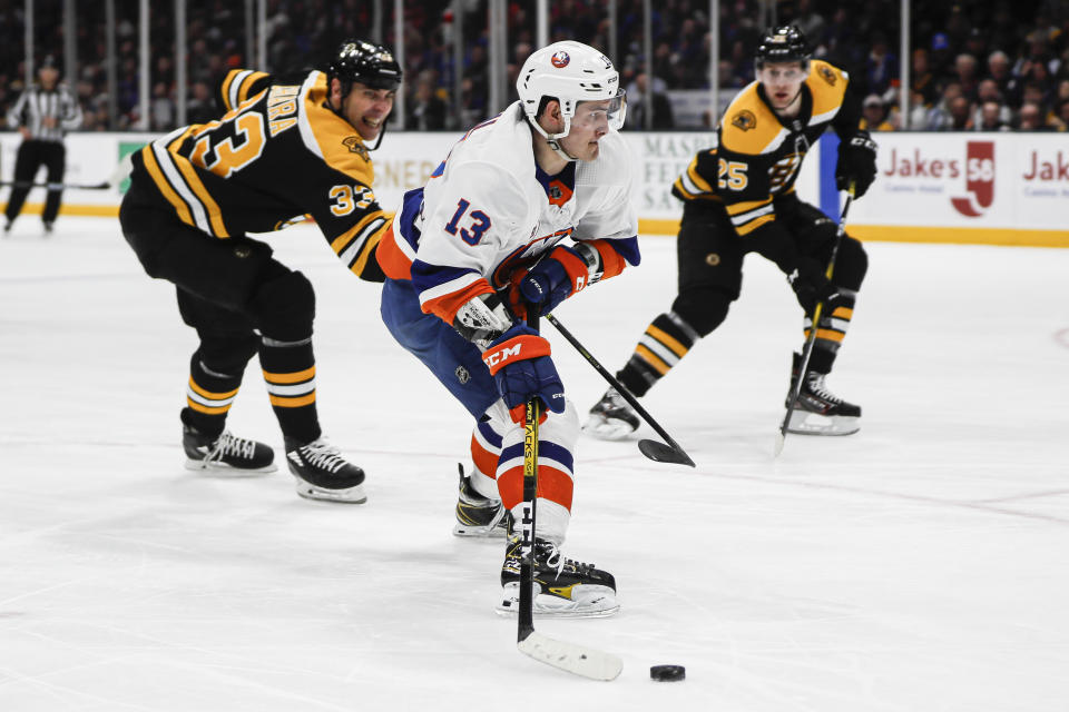 New York Islanders center Mathew Barzal (13) is slashed by Boston Bruins defenseman Zdeno Chara (33) on a breakaway drive to the net during the second period an NHL hockey game, Saturday, Feb. 29, 2020, in Uniondale, NY. (AP Photo/John Minchillo)