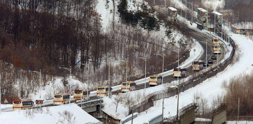 Buses carrying South Koreans cross the border line to Diamond Mountain resort in North Korea, at Goseong, South Korea, Thursday, Feb. 20, 2014. About 500 South Koreans will be reunited with their North Korean relatives at the Diamond Mountain resort in North Korea from Feb. 20 to 25. (AP Photo/Yonhap, Lee Jong-geun) KOREA OUT