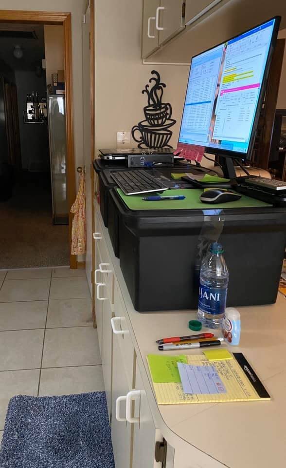 Billing analyst Elizabeth Goecke created a standing desk with three plastic storage boxes on her kitchen counter, and made a padded mat using two bath rugs folded in half. (Photo: Elizabeth Goecke)