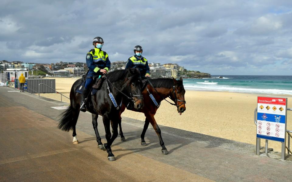 Mounted police patrol along Bondi Beach in Sydney - Joel Carrett/AAP via AP