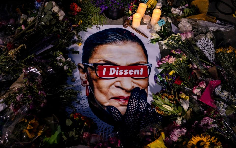 People left mementos in a makeshift memorial for Supreme Court Justice Ruth Bader Ginsburg in front of the US Supreme Court - Samuel Corum /Getty