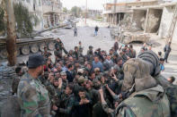 Syrian President Bashar al-Assad meets with Syrian army soldiers in eastern Ghouta, Syria, March 18, 2018. SANA/Handout via REUTERS