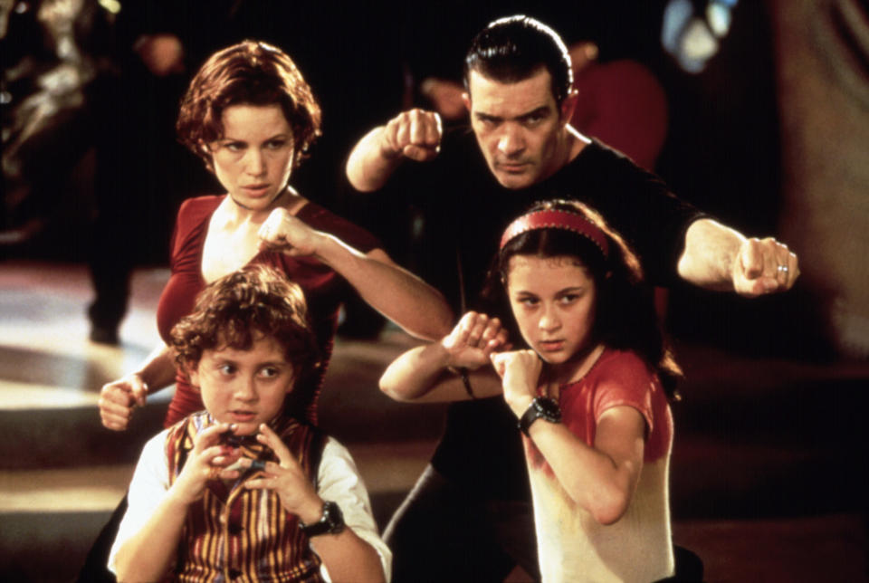 a woman, a man, and two kids holding up their fists