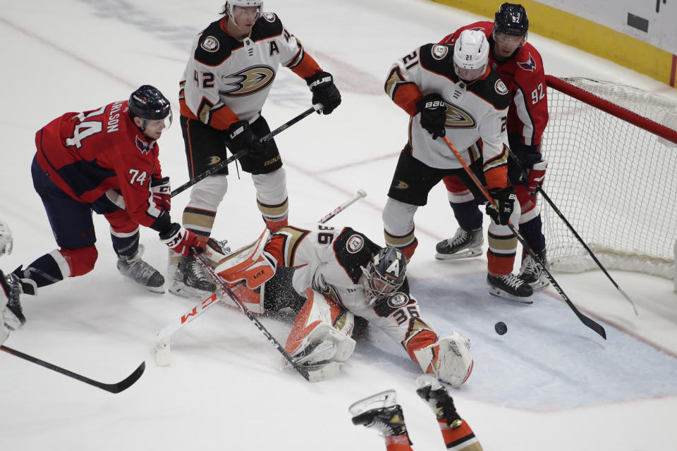 Washington Capitals' John Carlson (74) scores a goal against Anaheim Ducks goalie John Gibson (36) during the second period of an NHL hockey game, Monday, Dec. 6, 2021, in Washington. (AP Photo/Luis M. Alvarez)