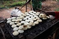 Volunteers help to prepare the meal for students at the San Agustin school in La Canada de Urdaneta