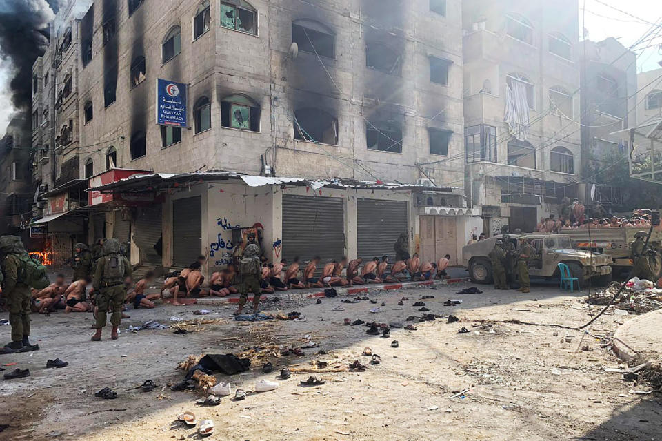 Images from social media appear to show Israeli forces detaining dozens of stripped men in Beit Lahia, northern Gaza. (Obtained by NBC News)