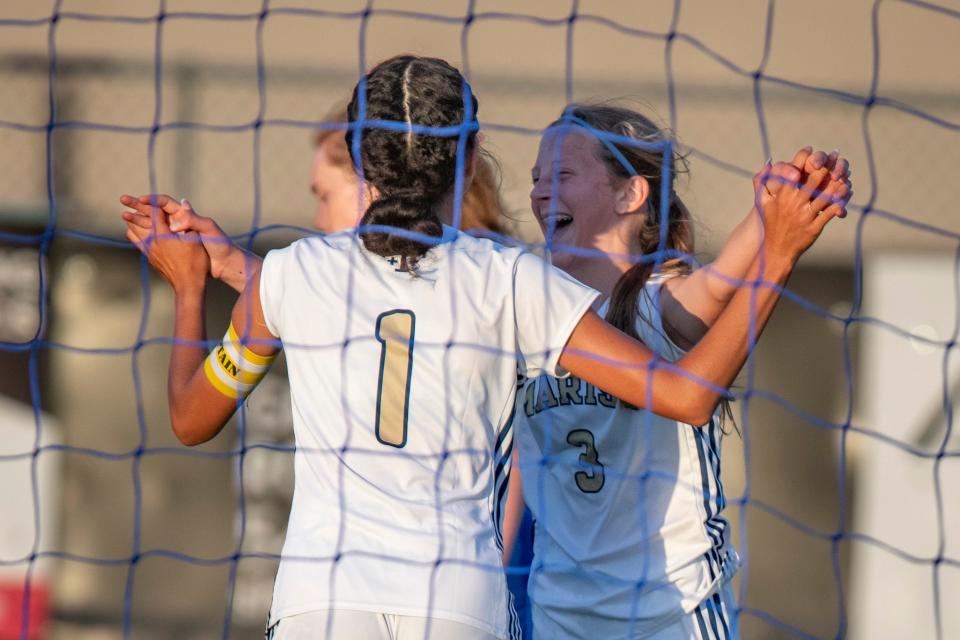 Marist’s Cloe Chase, left, and Tori Sherman celebrate a goal by Sherman as the Marist Spartans defeat the Churchill Lancers 6-0 Tuesday.