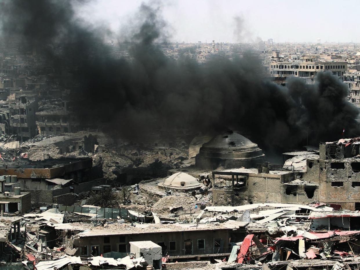 The women were arrested in Isis strongholds, including Mosul, where smoke is seen billowing here after a US airstrike last July before the city was re-captured from the militants: AHMAD AL-RUBAYE/AFP/Getty Images