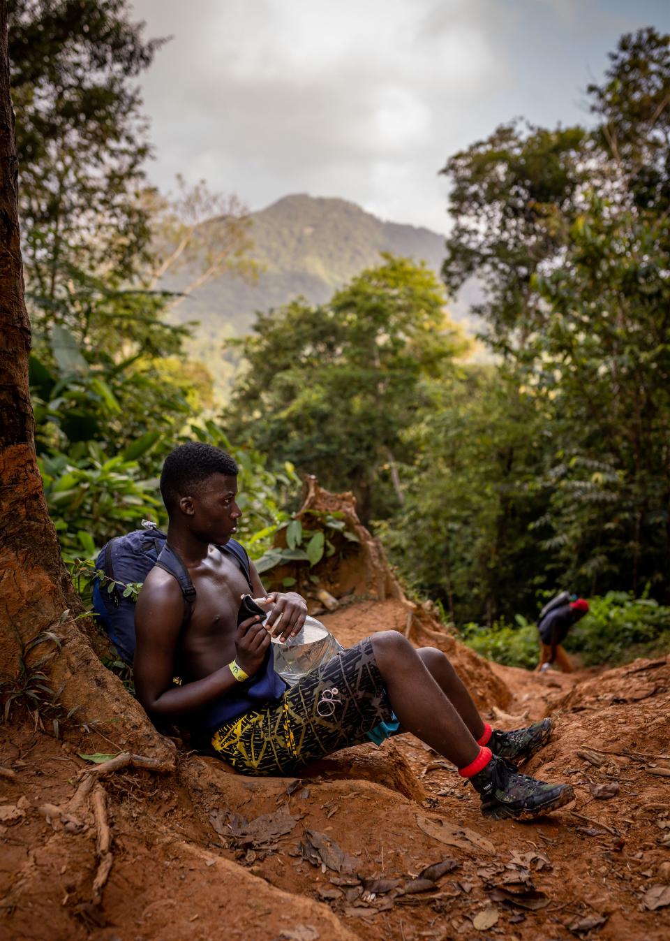 A young Haitian migrant rests on the first day of the journey through the Darién. | Spenser Heaps, Deseret News