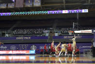 Washington plays Utah during the second half of an NCAA college basketball game, Sunday, Jan. 24, 2021, before empty seats in Hec Edmundson Pavilion in Seattle. Due to the COVID-19 pandemic, fans were not allowed to watch the game in person. (AP Photo/Ted S. Warren)