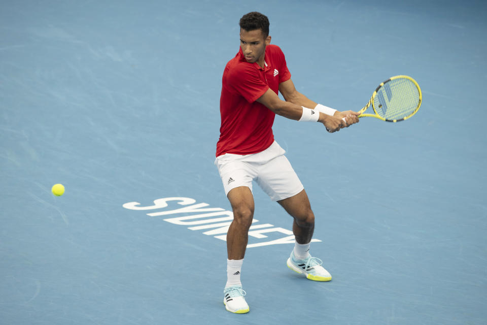 Felix Auger-Aliassime of Canada plays a shot against Russia's Daniil Medvedev during their semifinal match at the ATP Cup tennis tournament in Sydney, Saturday, Jan. 8, 2022. (AP Photo/Steve Christo)