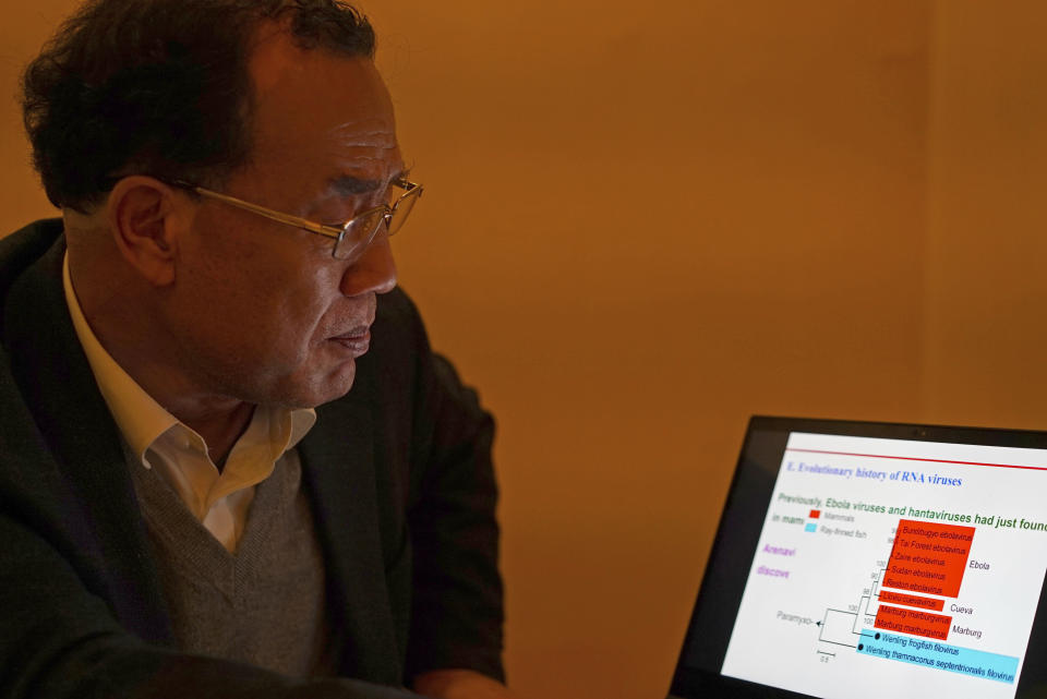 Zhang Yongzhen, the first scientist to publish a sequence of the COVID-19 virus, looks at a presentation on his laptop in a coffeeshop in Shanghai, China on Dec. 13, 2020. Zhang was staging a sit-in protest after authorities locked him out of his lab. Zhang wrote in an online post on Monday, April 29, 2024, that he and his team were suddenly notified they were being evicted from their lab, the latest in a series of setbacks, demotions and ousters since he first published the sequence in early January 2020.(AP Photo/Dake Kang)