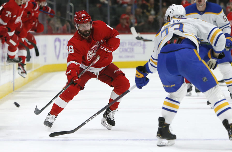 Detroit Red Wings center Sam Gagner (89) passes the puck against Buffalo Sabres defenseman Colin Miller (33) during the first period of an NHL hockey game Saturday, Nov. 27, 2021, in Detroit. (AP Photo/Duane Burleson)