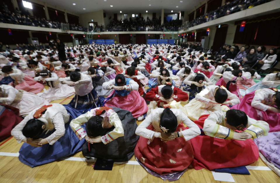 In this Thursday, Feb. 14, 2019, file photo, South Korean seniors clad in traditional attire bow during a joint graduation and coming-of-age ceremony at Dongmyung Girls' High School in Seoul South Korea. (AP Photo/Ahn Young-joon, File)