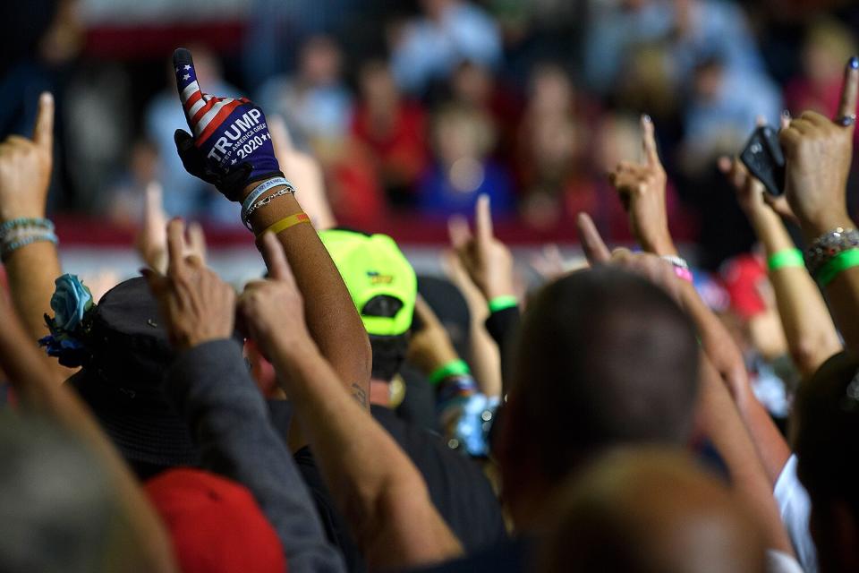 Audience members put their index finger up to symbolize America First while President Donald Trump speaks at a Save America Rally to support Republican candidates running for state and federal offices in the state of Ohio at the Covelli Centre on September 17, 2022 in Youngstown, Ohio.