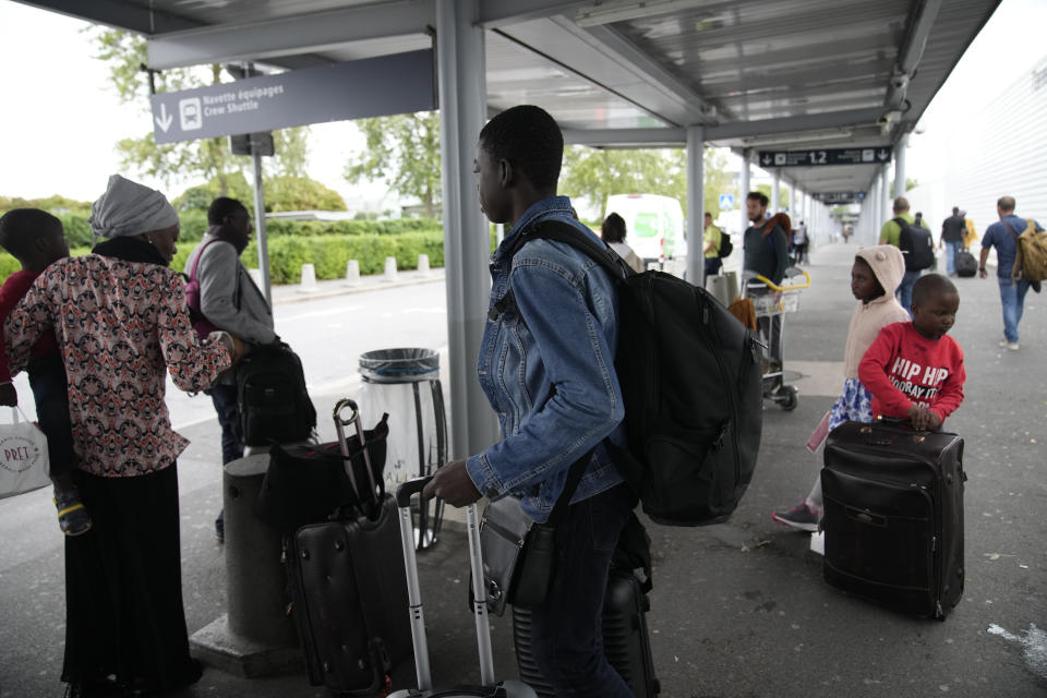 People arrive after being evacuated from Niger at the Roissy Charles de Gaulle airport, north of Paris, France, Wednesday, Aug. 2, 2023. European militaries are continuing to evacuate foreign nationals from Niger, with a third French military flight expected to depart the African nation's capital. Defense chiefs from West Africa's regional bloc are set to meet to discuss last week's coup against the country's democratically elected president. (AP Photo/Christophe Ena)