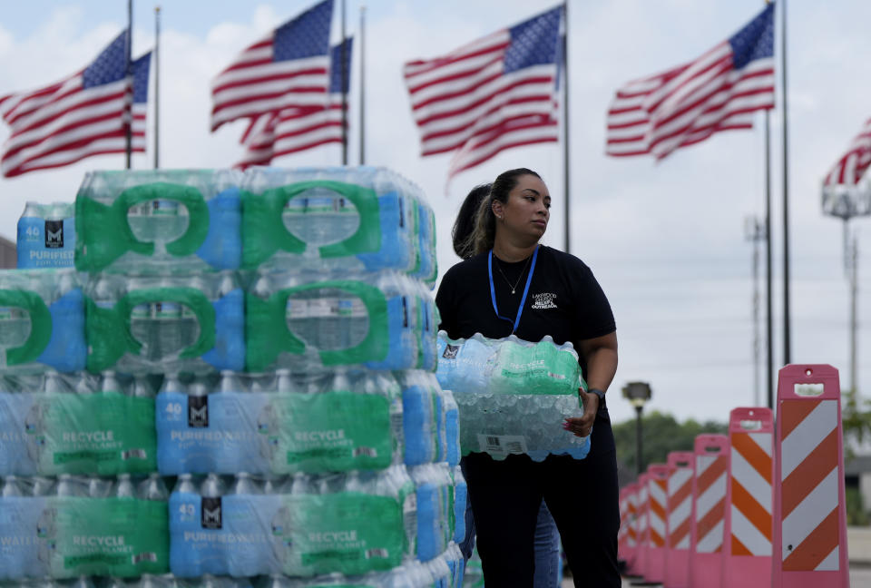 Staff at Lakewood Church hand out water and operate a cooling station in Houston, Tuesday, July 9, 2024. The effects of Hurricane Beryl left most in the area without power. (AP Photo/Eric Gay)