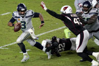 Seattle Seahawks quarterback Russell Wilson (3) escapes the reach of Arizona Cardinals strong safety Budda Baker (32) as outside linebacker Haason Reddick (43) pursues during the second half of an NFL football game, Sunday, Oct. 25, 2020, in Glendale, Ariz. (AP Photo/Ross D. Franklin)