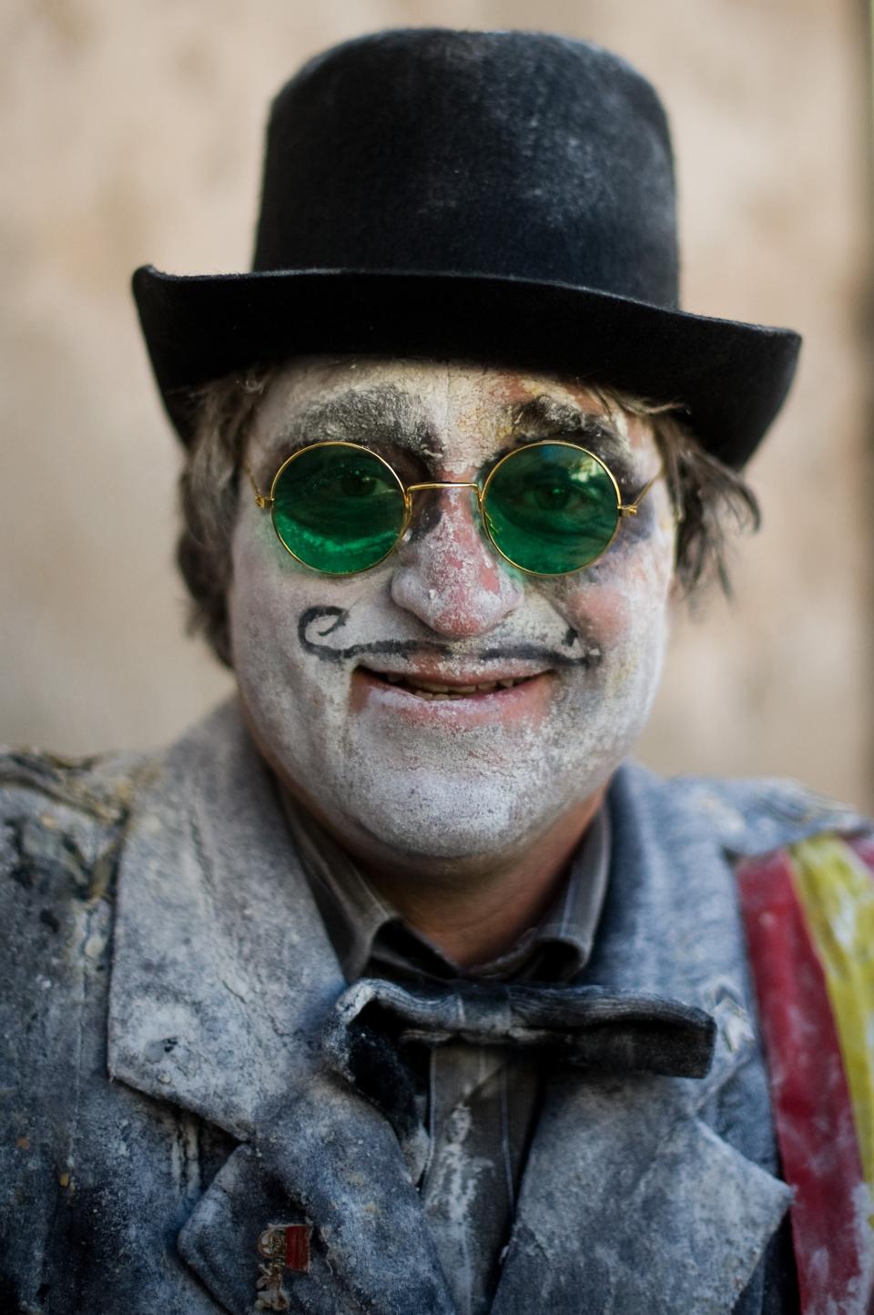 IBI, SPAIN - DECEMBER 28: A Reveller poses after taking part in the battle of 'Enfarinats', a flour fight in celebration of the Els Enfarinats festival on December 28, 2012 in Ibi, Spain. Citizens of Ibi annually celebrate the festival with a battle using flour, eggs and firecrackers. The battle takes place between two groups, a group of married men called 'Els Enfarinats' which take the control of the village for one day pronouncing a whole of ridiculous laws and fining the citizens that infringe them and a group called 'La Oposicio' which try to restore order. At the end of the day the money collected from the fines is donated to charitable causes in the village. The festival has been celebrated since 1981 after the town of Ibi recovered the tradition but the origins remain unknown. (Photo by David Ramos/Getty Images)