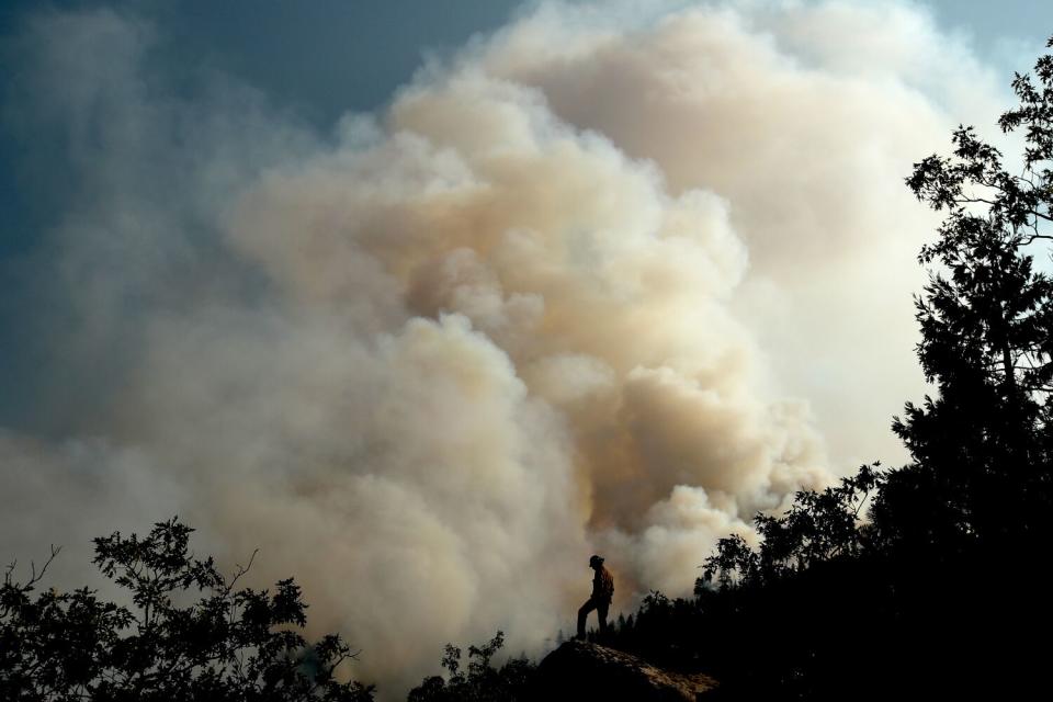 A huge plume of smoke billows skyward as the Dixie Fire burns near Janesville in Aug. 2021.