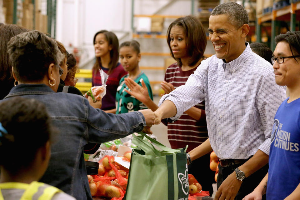 The Obamas packed and distributed bags of food at the Capital Area Food Bank in Washington, DC, in 2013. (Photo: WHITE HOUSE POOL (ISP POOL IMAGES) via Getty Images)