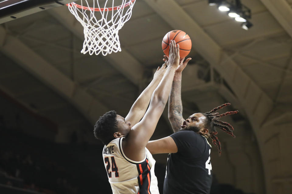 Colorado center Eddie Lampkin Jr., right, drives to the basket as Oregon State center KC Ibekwe (24) defends during the second half of an NCAA college basketball game Saturday, March 9, 2024, in Corvallis, Ore. (AP Photo/Amanda Loman)