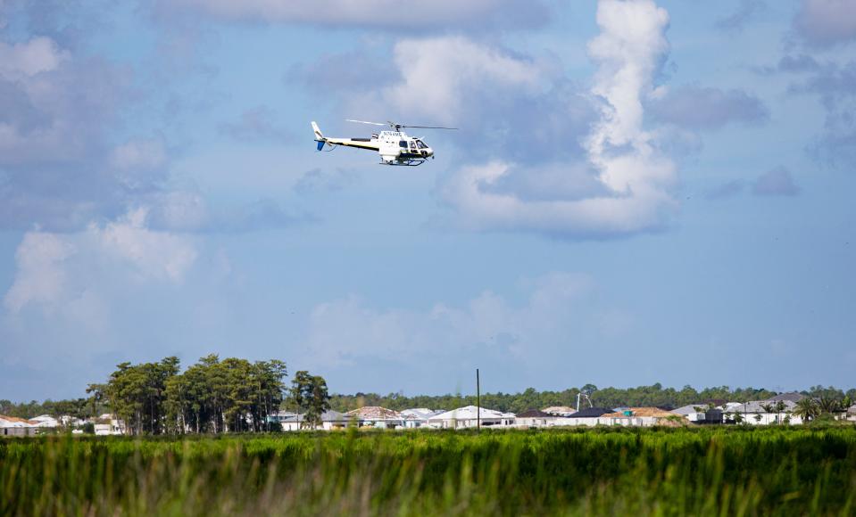 A pilot for Lee County Mosquito Control disperses mosquito larvicide in an area east of the new Verdana development off of Corkscrew Road on Wednesday, August 31, 2022. 