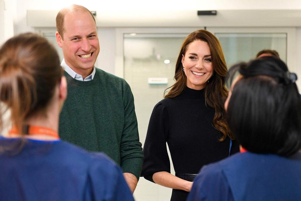 Prince William (L), Prince of Wales, and Britain's Catherine, Princess of Wales, meet with staff during a visit to the Royal Liverpool University Hospita