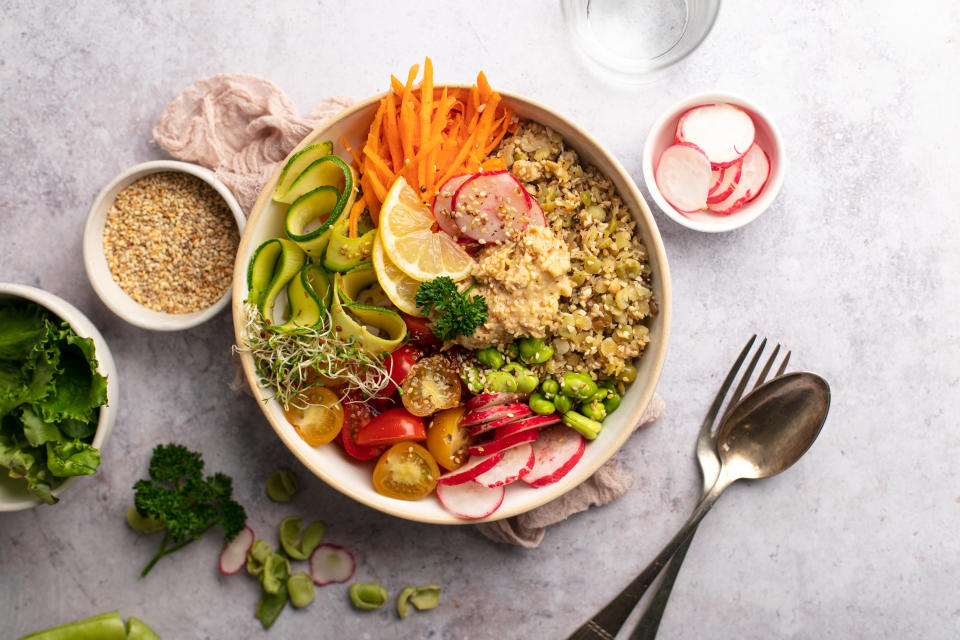 vegan plate with quinoa, vegetables and a glass of water