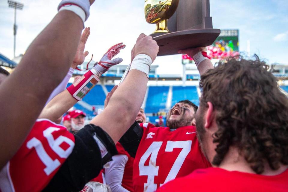 Belfry’s Zachary Savage (47) celebrates with his teammates after Belfry beat Paducah Tilghman on Saturday for the school’s eight state championship.