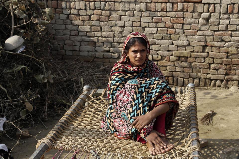 In this Tuesday, Dec. 20, 2016 photo, Saima, who was married to a 36 year-old man in her early teens, sits in her home in Jampur, Pakistan. Saima was given as a bride to an older man by her father so he could marry the groom’s sister, a practice of exchanging girls that is entrenched in conservative regions of Pakistan. It even has its own name in Urdu: Watta Satta, “give and take.” A mix of interests _ family obligations, desire for sons, a wish to hand off a girl to a husband _ can lead to a young teen in an a marriage she never sought.(AP Photo/K.M. Chaudhry)