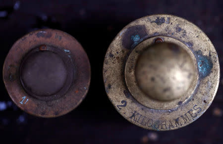 A one and two kilogram weights are seen in Saussay-la-Campagne, western France, November 15, 2018. REUTERS/Christian Hartmann