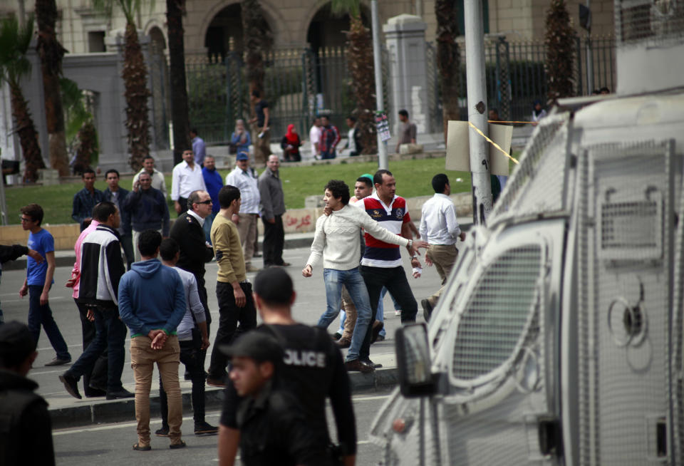 Egyptian security forces detain people after multiple explosions hit the area outside the main campus of Cairo University, killing at least two, in Giza, Egypt, Wednesday, April 2, 2014. The bombings targeted riot police routinely deployed at the location in anticipation of near-daily protests by students who support ousted Islamist President Mohammed Morsi and his Muslim Brotherhood group. (AP Photo/Sabry Khaled, El Shorouk Newspaper) EGYPT OUT