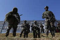 South Korean marines stand in attention during their regular drill on Yeonpyeong Island, South Korea Thursday, Nov. 1, 2018. The U.S. and South Korea are reviewing whether they will conduct large-scale military exercises next year and will decide before December. South Korean Defense Minister Jeong Kyeong-doo told reporters Wednesday at the Pentagon that if more exercises are suspended the two countries will conduct other training to mitigate the lapse. He says the review will be done by Nov. 15. (Jeon Heon-kyun/Pool Photo via AP)
