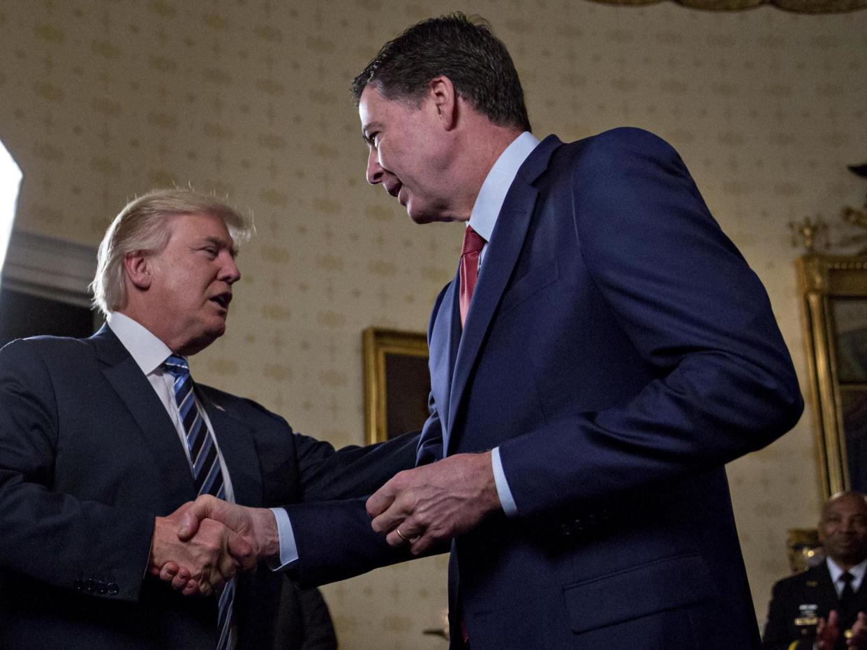 Donald Trump shakes hands with FBI director James Comey on 22 January 2017: Getty Images