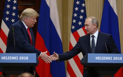 President Donald Trump shakes hands with Russian President Vladimir Putin during a joint press conference at the Presidential Palace in Helsinki, Finland on July 16 - Credit: Barcroft/UPI