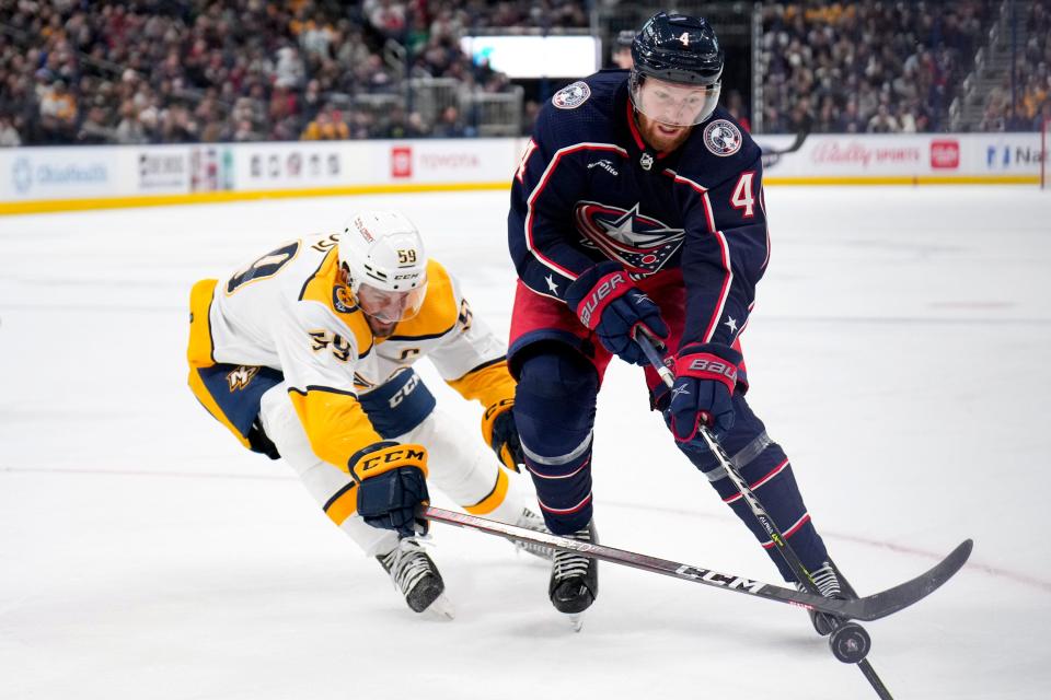 Oct 20, 2022; Columbus, Ohio, USA;  Columbus Blue Jackets defenseman Vladislav Gavrikov (4) is defended by Nashville Predators defenseman Roman Josi (59) during the third period of the hockey game between the Columbus Blue Jackets and the Nashville Predators at Nationwide Arena. Mandatory Credit: Joseph Scheller-The Columbus Dispatch