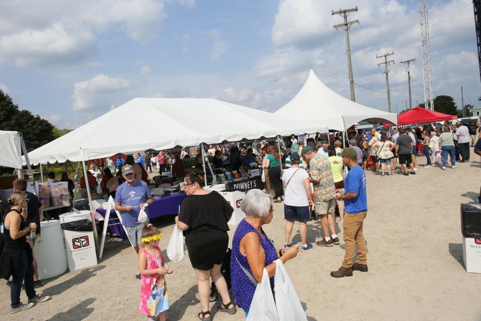 Crowds of people gather around vendor tents during the MI New Favorite Snack competition at Vantage Point in Port Huron on Saturday, Sept. 17, 2022.