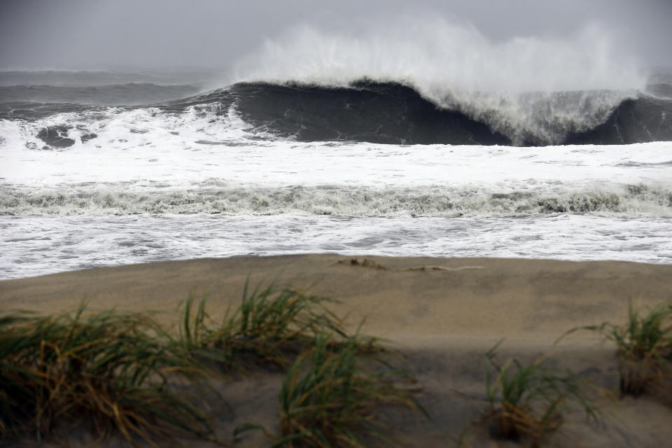 A huge wave crashes on the beach as Hurricane Sandy bears down on the East Coast, Monday, Oct. 29, 2012, in Ocean City, Md. Hurricane Sandy continued on its path Monday, as the storm forced the shutdown of mass transit, schools and financial markets, sending coastal residents fleeing, and threatening a dangerous mix of high winds and soaking rain. (AP Photo/Alex Brandon)