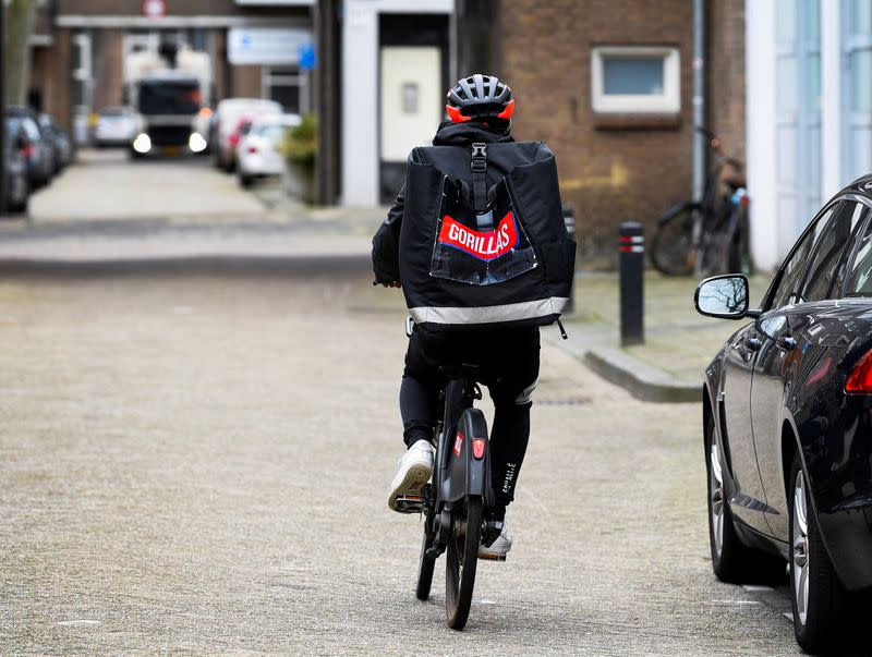 FILE PHOTO: A courier of the fast grocery deliverer Gorillas rides a bike in Rotterdam, Netherlands