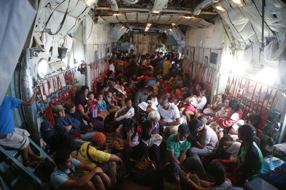 Typhoon survivors are pictured in the hold of a C-130 military transport plane at Tacloban airport in central Philippines