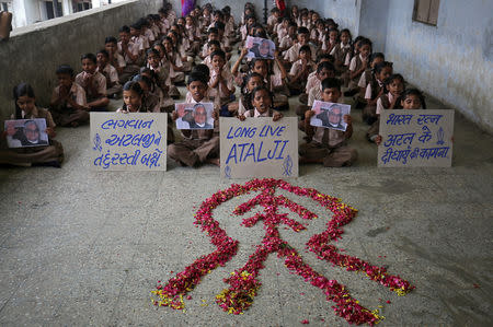 Schoolchildren pray for the speedy recovery of India's former prime minister Atal Bihari Vajpayee, inside a school in Ahmedabad, India, August 16, 2018. REUTERS/Amit Dave