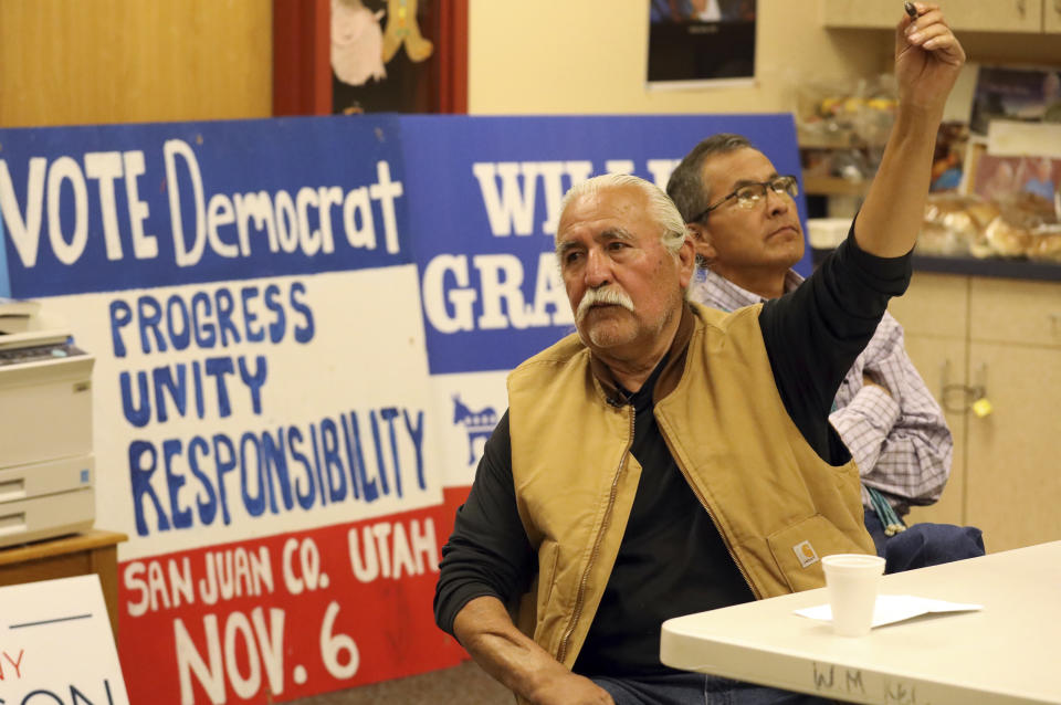 In this Oct. 24, 2018, photo, Democratic county commission candidate Willie Grayeyes, left, speaks to a group while Kenneth Maryboy, a Navajo who is running unopposed for another seat on the commission, looks on in White Mesa, Utah. Grayeyes is running in a new, 65-percent Navajo district on local issues like new school buses and better road maintenance. If Grayeyes wins, the three-person commission could be majority Navajo for the first time. (AP Photo/Rick Bowmer)