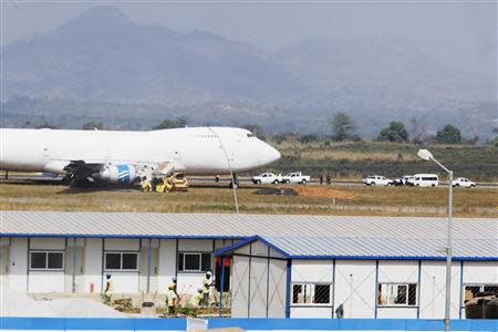 Officials inspect a Saudi Air Boeing 747 cargo aircraft after it overran the runway crashing into a tanker truck at the Nnamdi Azikiwe International Airport in Abuja December 5, 2013. REUTERS/Afolabi Sotunde