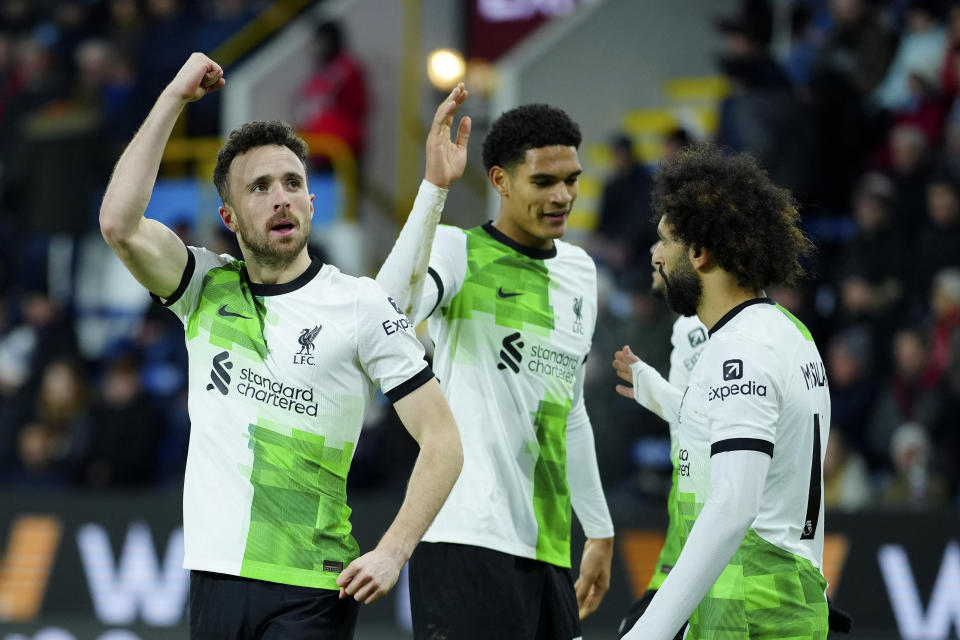 Liverpool's Diogo Jota, left, celebrates scoring his sides second goal during the English Premier League soccer match between Burnley and Liverpool at Turf Moor stadium in Burnley, England, Tuesday, Dec. 26, 2023. (AP Photo/Jon Super)