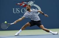 Benoit Paire of France hits a return against Kei Nishikori of Japan during their match at the U.S. Open Championships tennis tournament in New York, August 31, 2015. REUTERS/Mike Segar