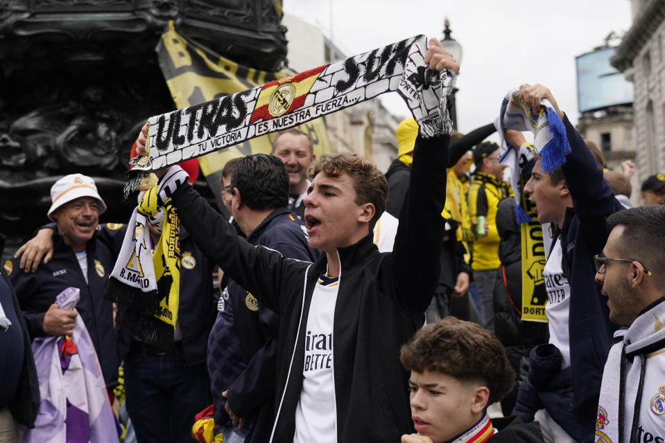 Real Madrid supporters react as they gather near Piccadilly Circus in central London ahead of the Champions League final soccer match between Borussia Dortmund and Real Madrid which will take place at Wembley stadium later, Saturday, June 1, 2024. (AP Photo/Alberto Pezzali)